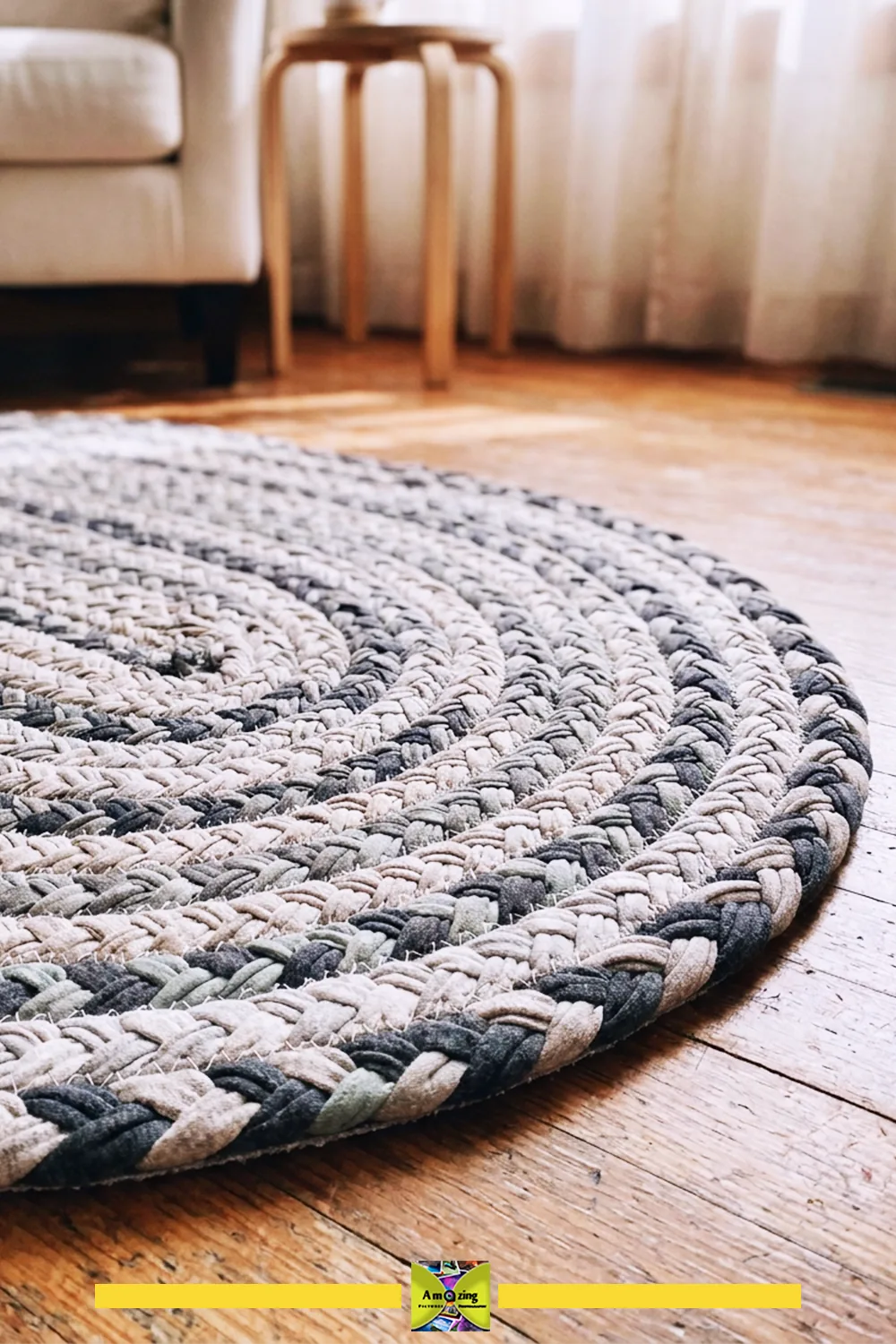 Close-up of a braided t-shirt rug on a wooden floor in a sunlit living room corner