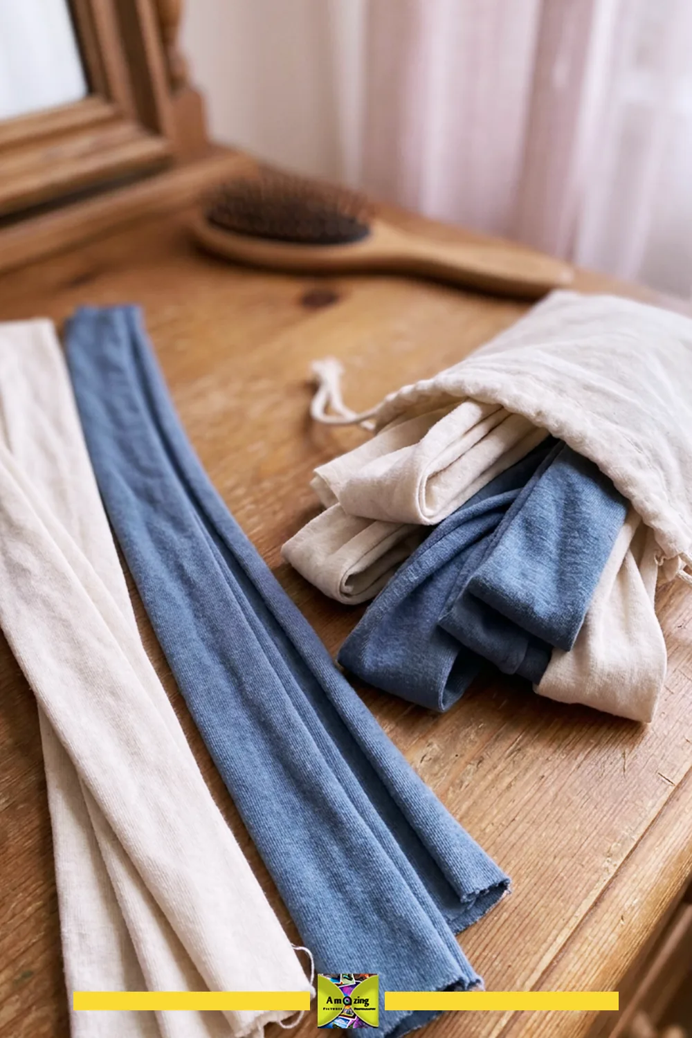 Cotton t-shirt strips in blue and cream colors laid out on a wooden vanity next to a brush and drawstring bag.