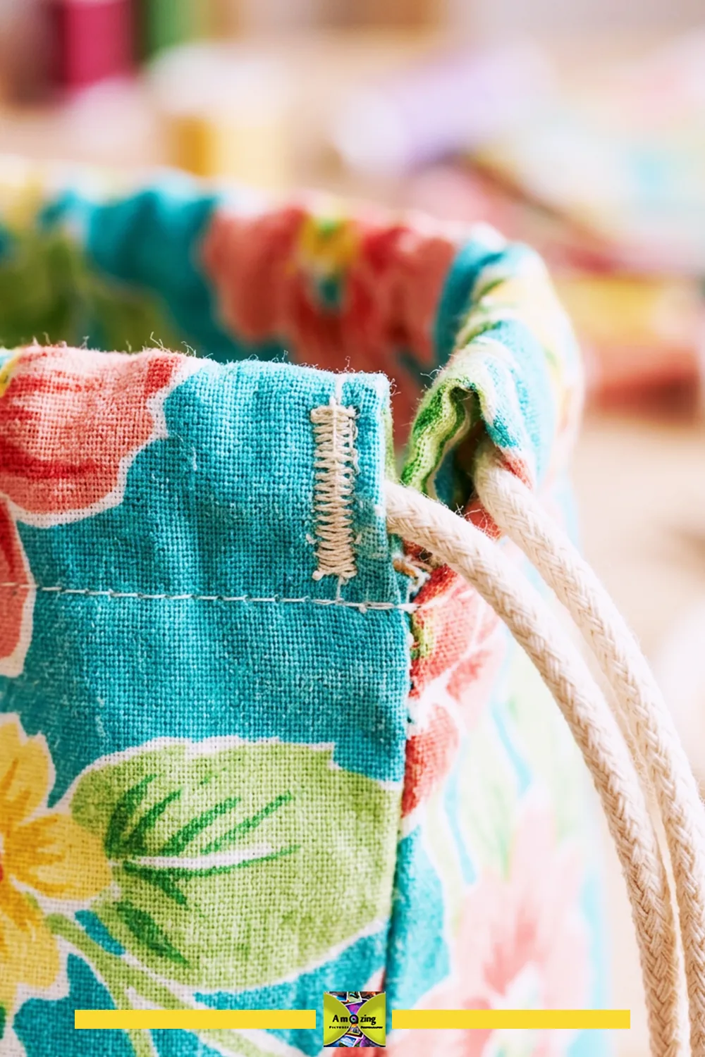 Close-up of a floral fabric drawstring bag showing a reinforced stitched channel opening