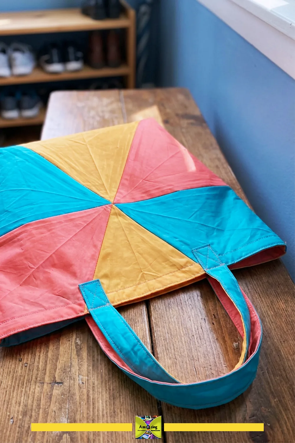 Colorful fold-flat tote bag with geometric pattern lying on a wooden table