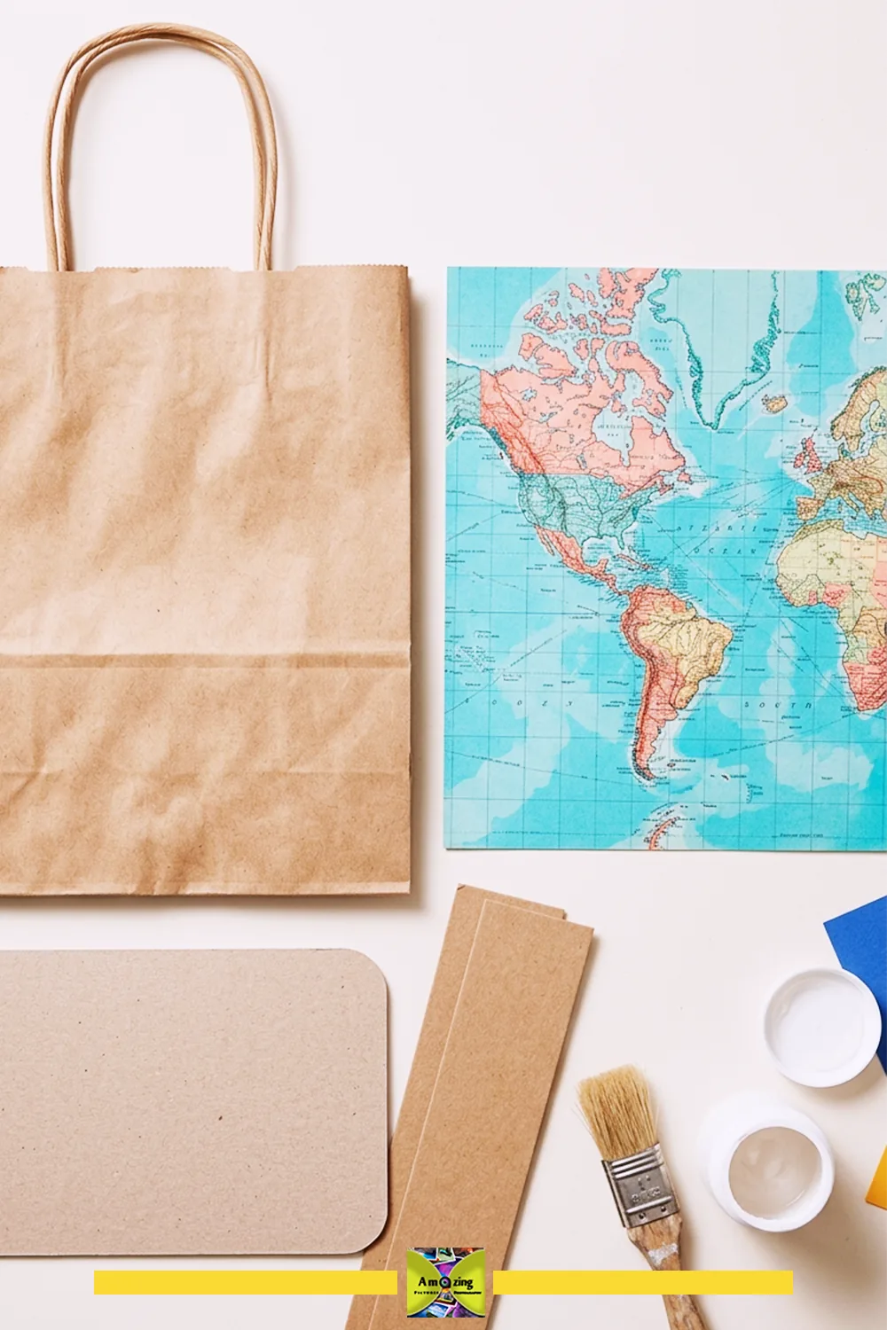 Kraft gift bag, map paper, card reinforcements, brush, and glue arranged before assembly.
