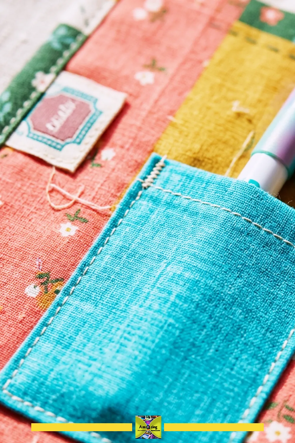 Close-up of a handmade sewing mat with a blue stitched pocket holding a pen