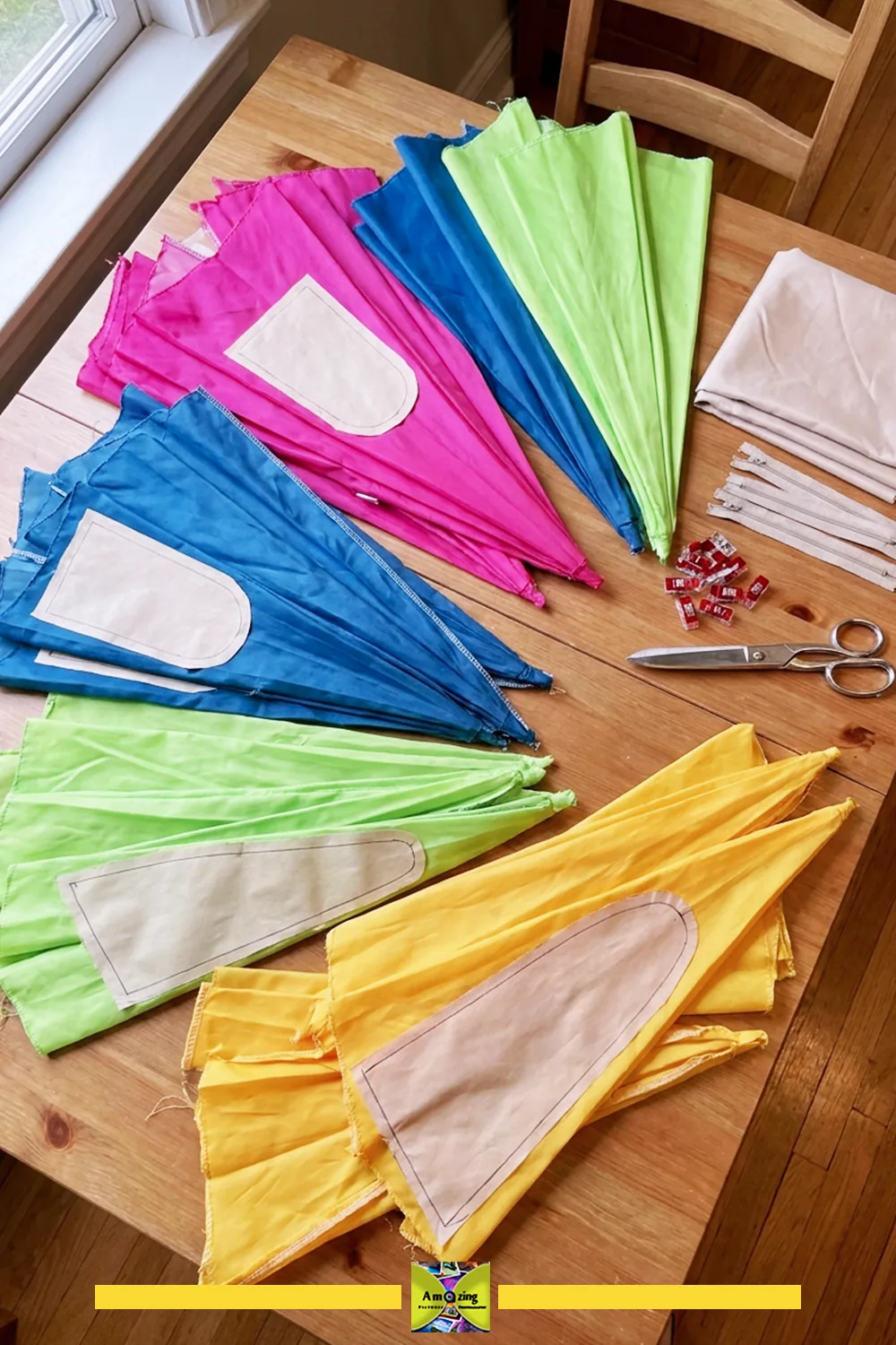 Stacks of colorful fabric wedges with beige pockets on a wooden table, ready for cutting and sewing.