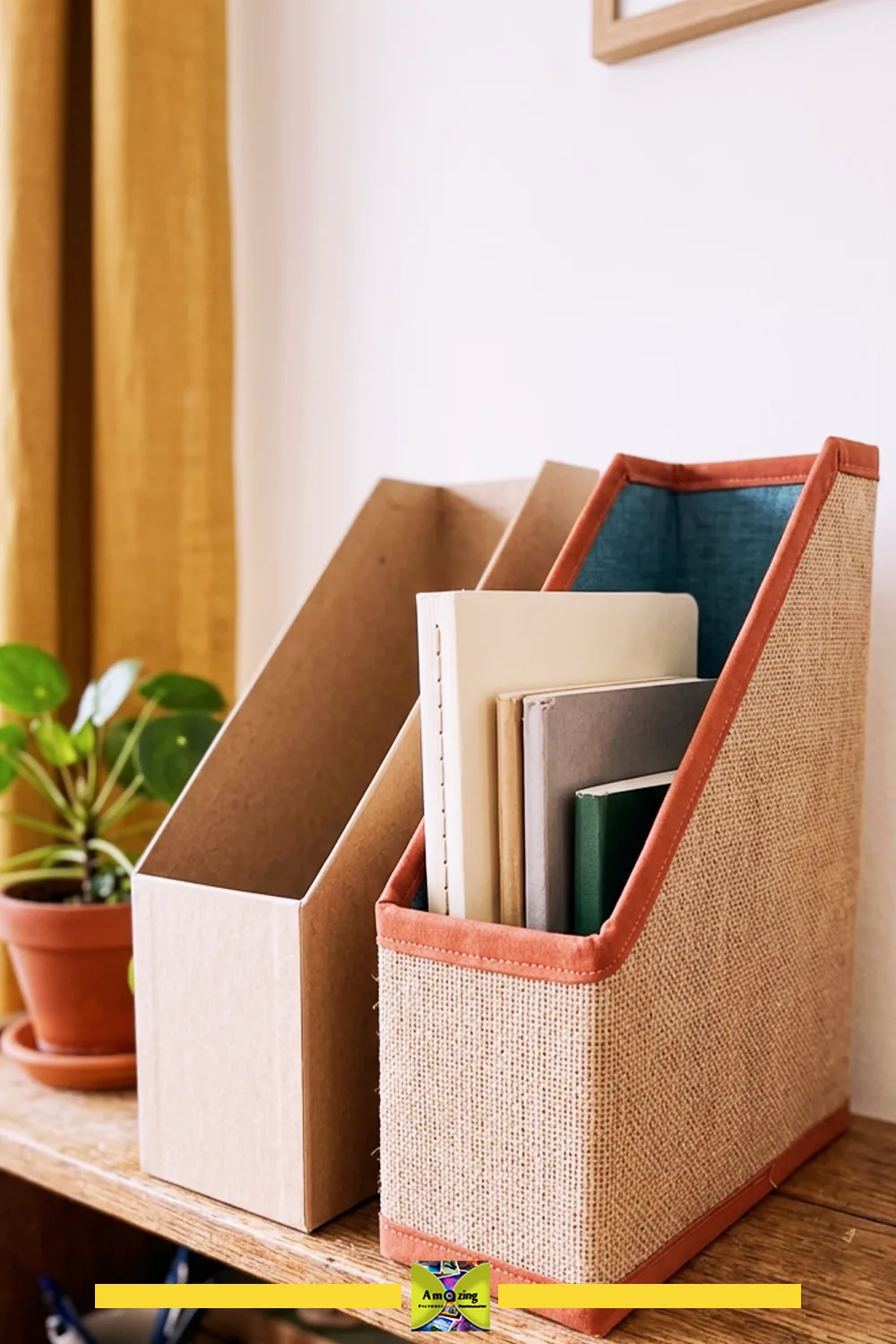 Two magazine file sleeves on a wooden shelf, one plain cardboard and one finished with fabric and trim.