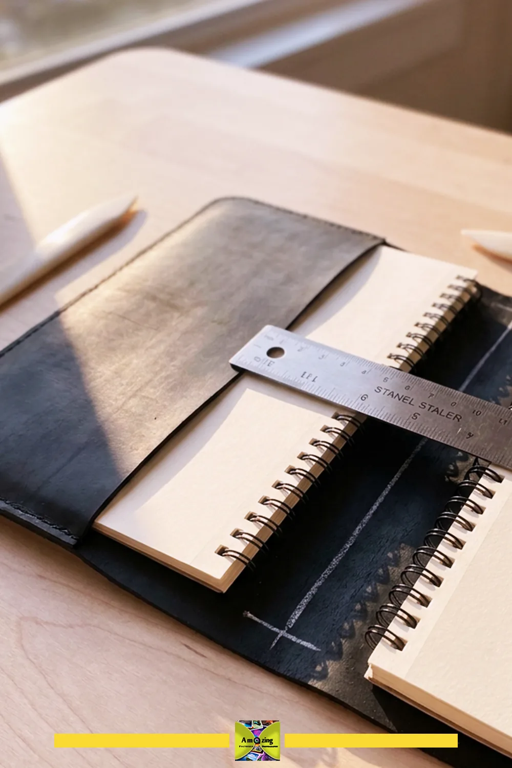 Black rubber notebook jacket with the spine clearance being measured against an open notebook