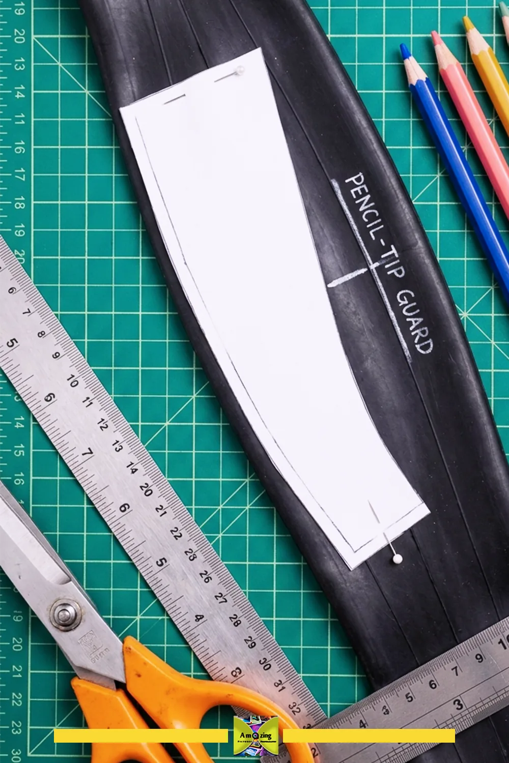 Paper pattern laid over a flattened black inner tube with the pencil-tip guard position marked