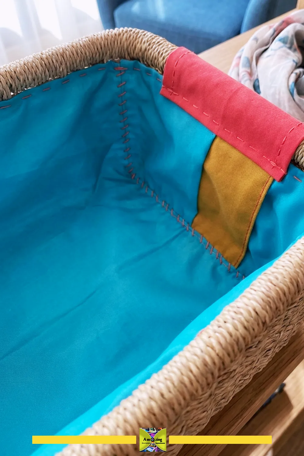 Close-up of a woven basket with a colorful, fitted fabric lining and stitched corners.