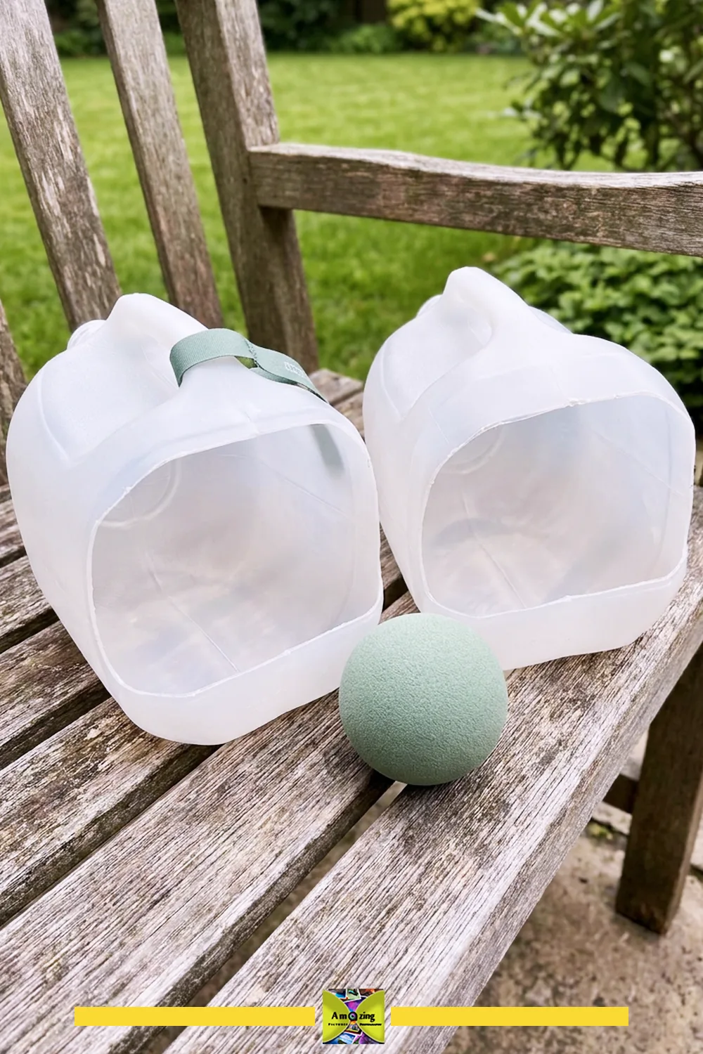 Two homemade scoop and catch game scoops made from plastic jugs and a green ball on a wooden bench