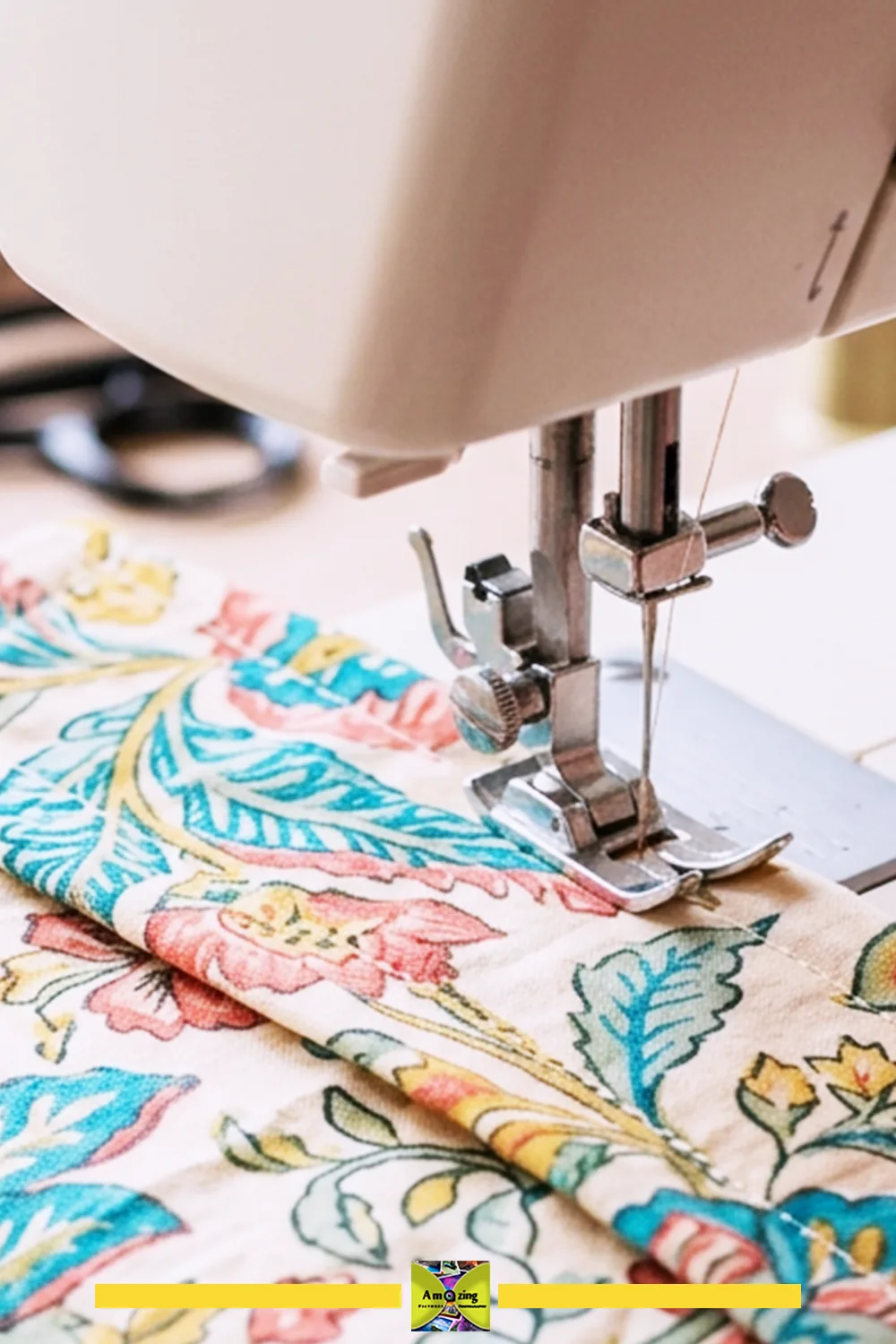 Close-up of a sewing machine stitching a floral fabric for a shelf curtain header.