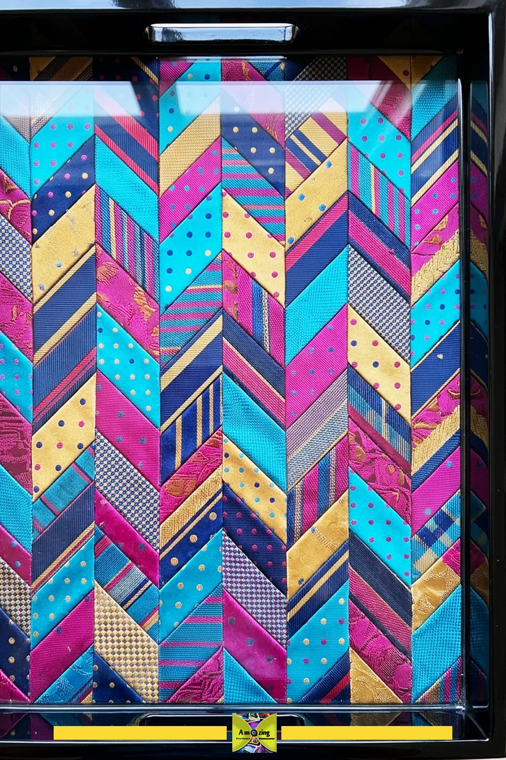 Necktie fabric composition sealed beneath the transparent tray panel