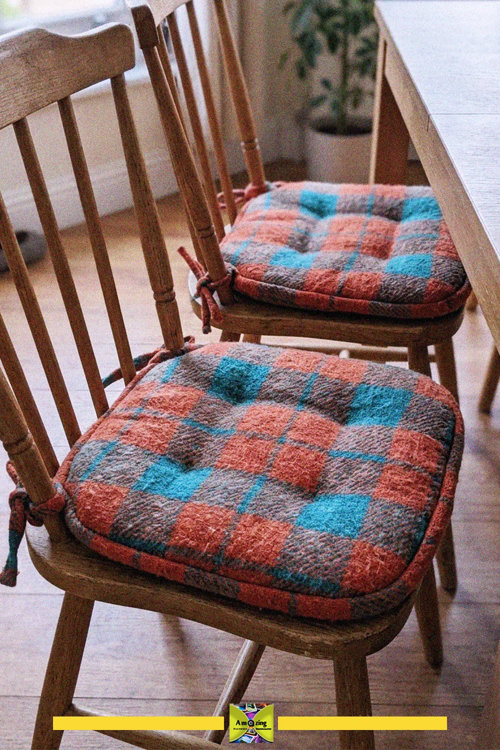 Two wooden dining chairs with tufted checkered cushions made from an old blanket
