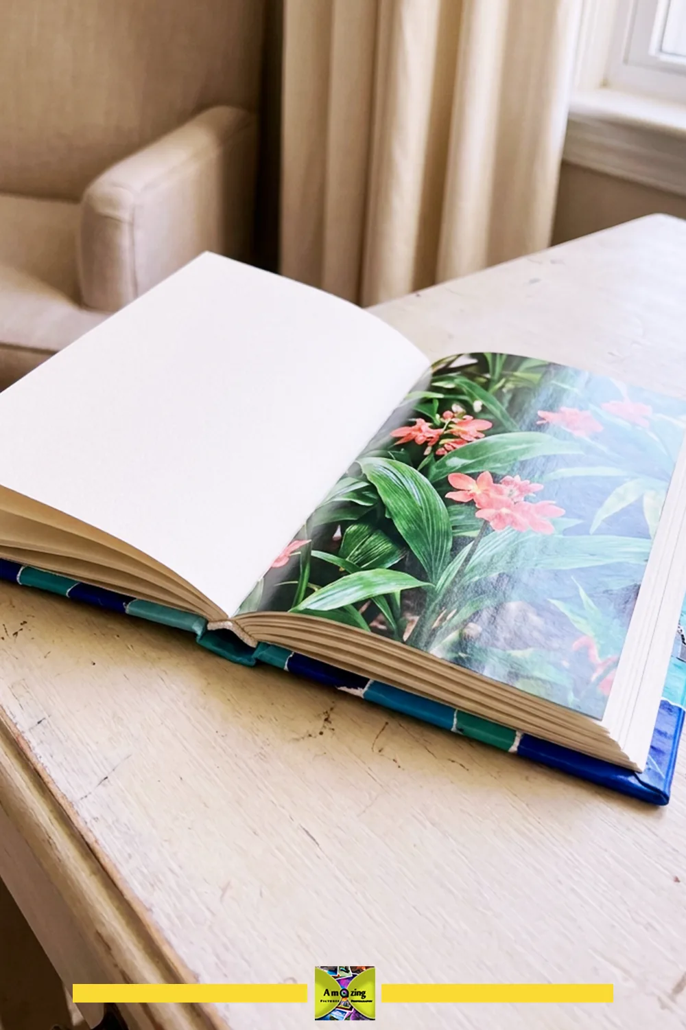 Open DIY journal with blank and floral magazine pages on a wooden desk