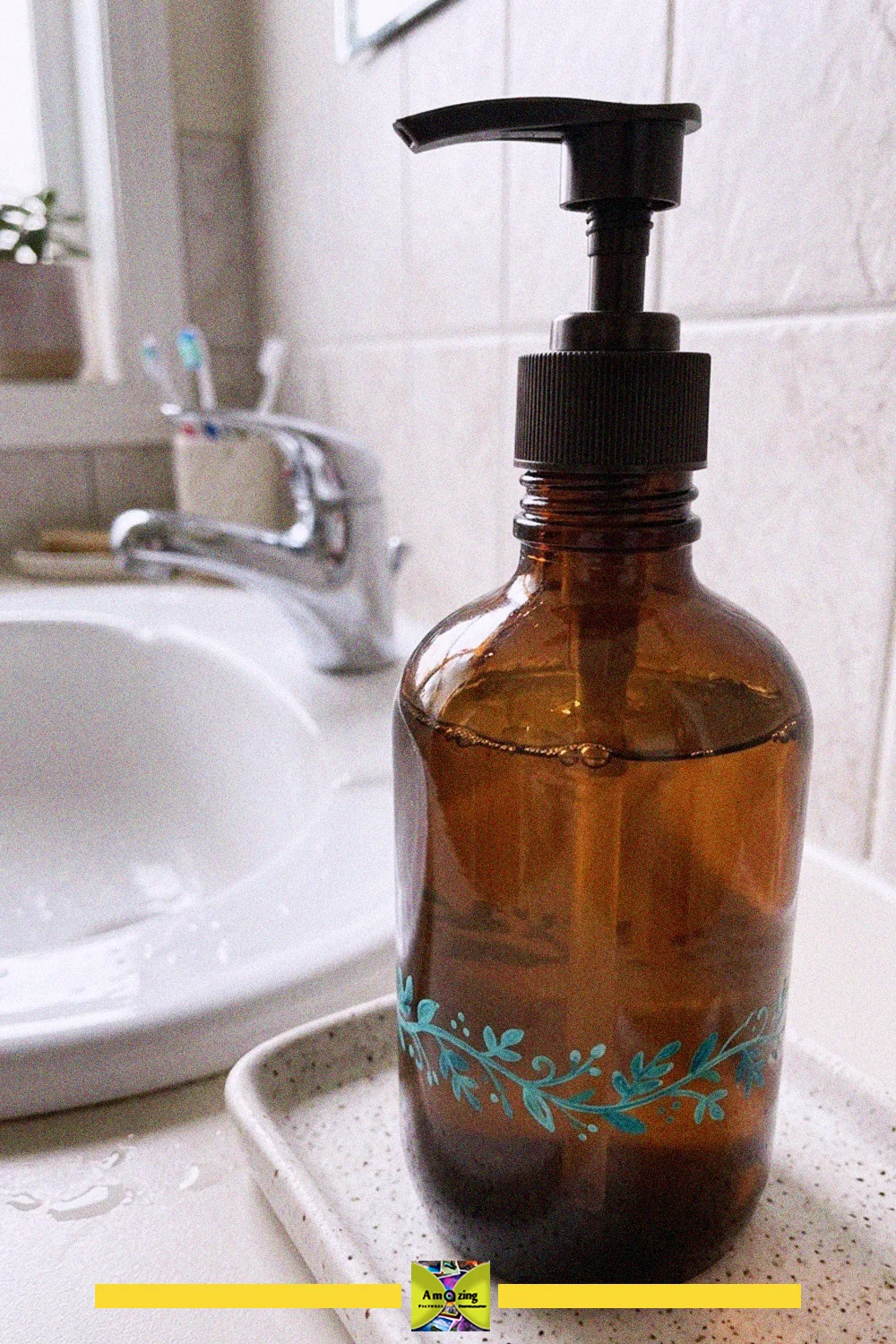 Bathroom glass bottle crafts: an upcycled amber bottle with a black pump used as a hand soap dispenser